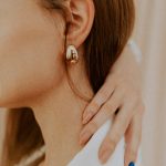 woman wearing silver diamond stud earring