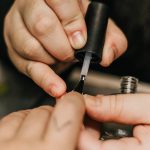 person holding black and silver hand tool