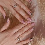 a woman's hands with manicured nails and a ring