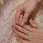 a woman's hands with a manicure and a ring