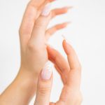a woman's hands with a manicured nail polish