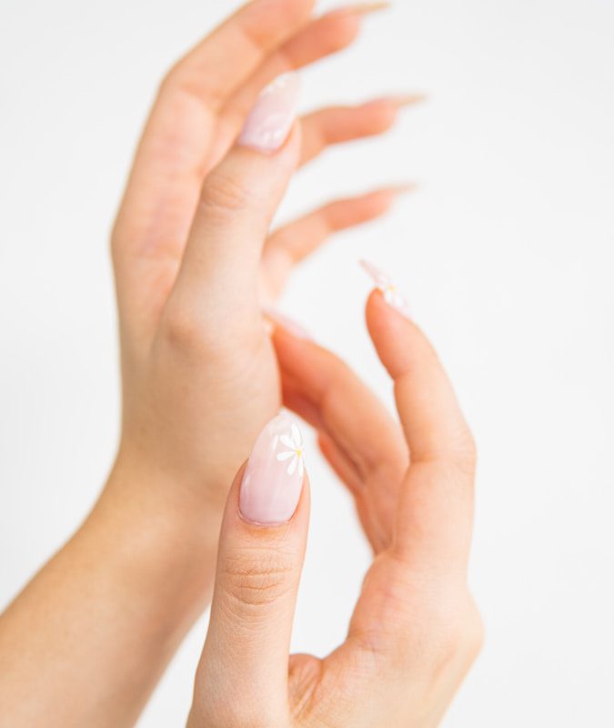 a woman's hands with a manicured nail polish