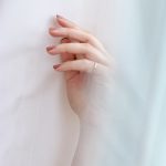 woman wearing gold-colored ring