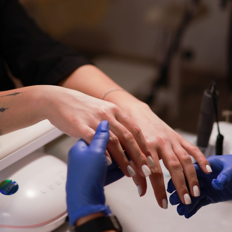 a woman getting her nails done at a salon