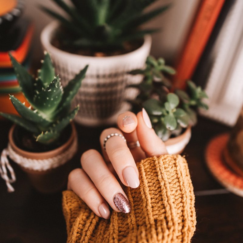 person holding brown woven basket