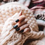 person wearing white knit sweater