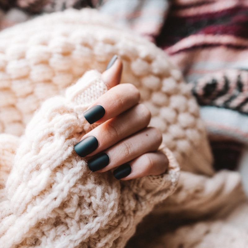 person wearing white knit sweater