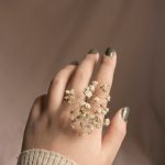 person with white flower on hand