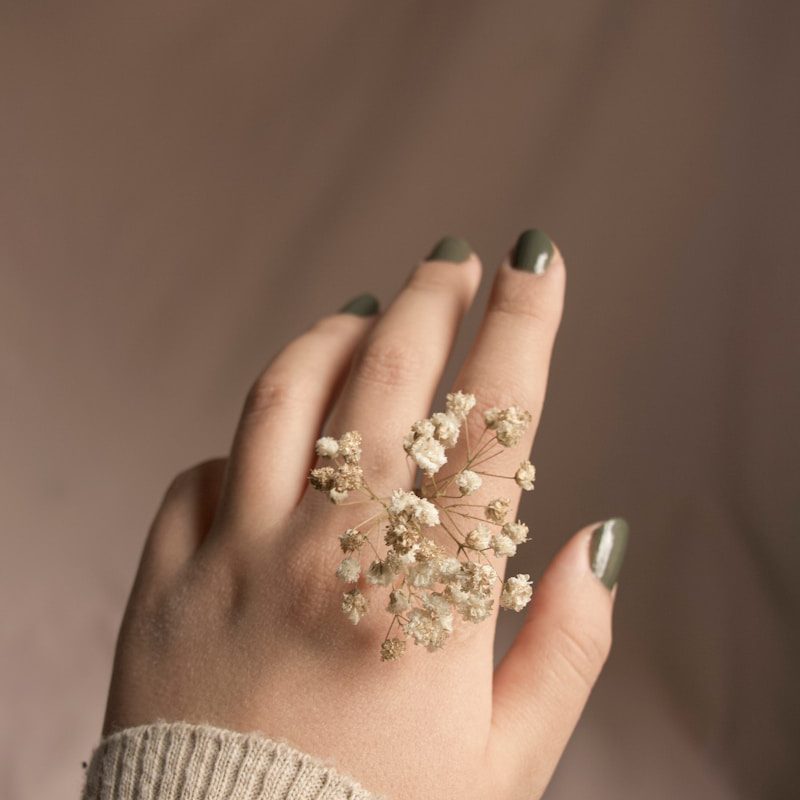 person with white flower on hand