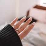 person wearing silver ring and black long sleeve shirt
